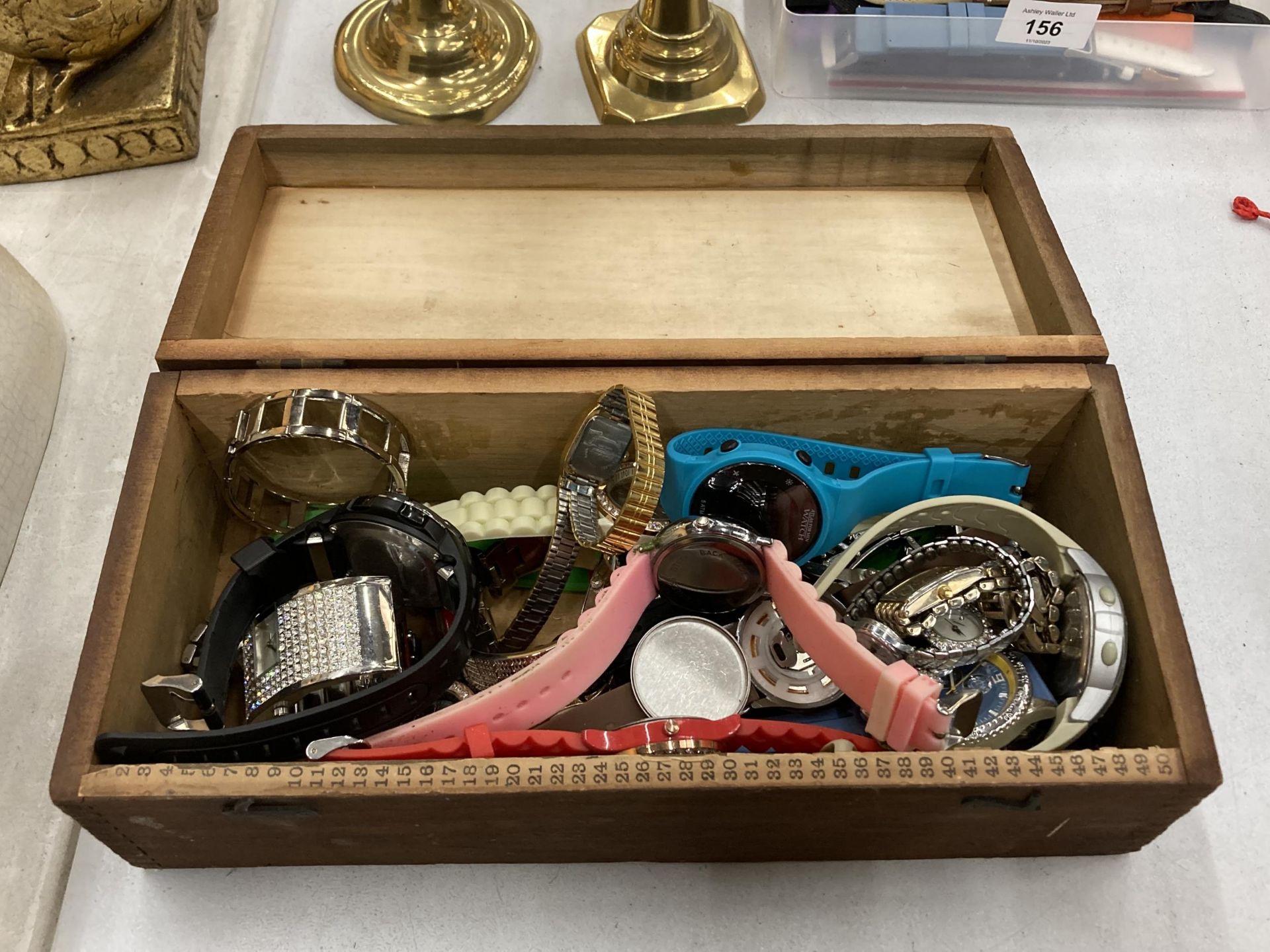A VINTAGE WOODEN BOX CONTAINING A QUANTITY OF WRISTWATCHES TO INCLUDE LIMIT, SEKONDA, ETC