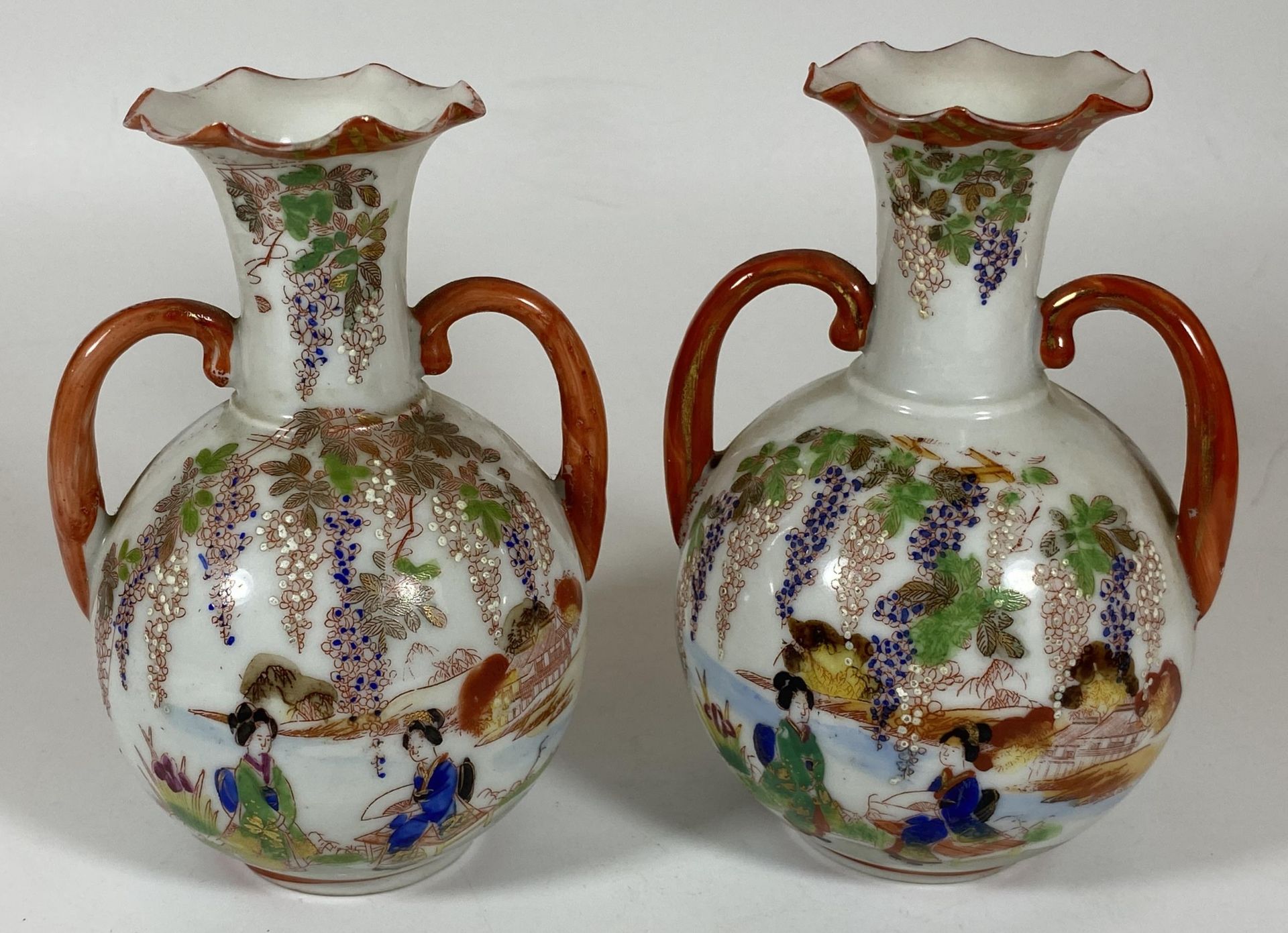 A PAIR OF JAPANESE TWIN HANDLED PORCELAIN VASES WITH LAKESIDE SCENE, HEIGHT 14CM
