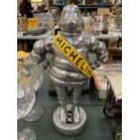 A VERY HEAVY MICHELIN MAN ON A TYRE, HEIGHT APPROX 37CM