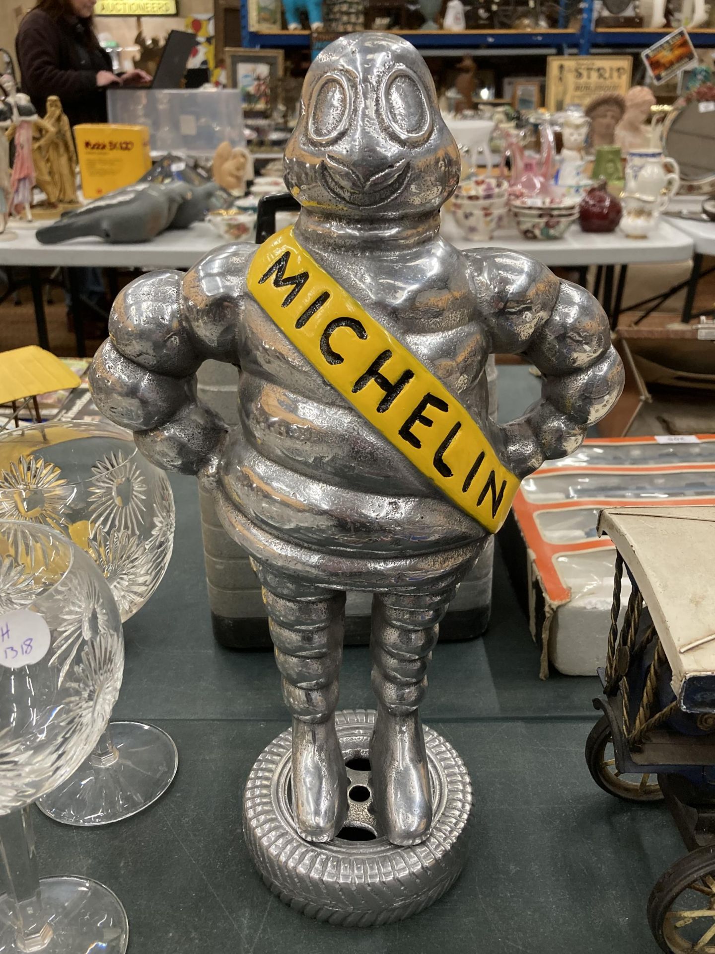 A VERY HEAVY MICHELIN MAN ON A TYRE, HEIGHT APPROX 37CM