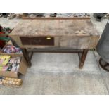A VINTAGE WOODEN WORK BENCH ENCLOSING A SINGLE DRAWER