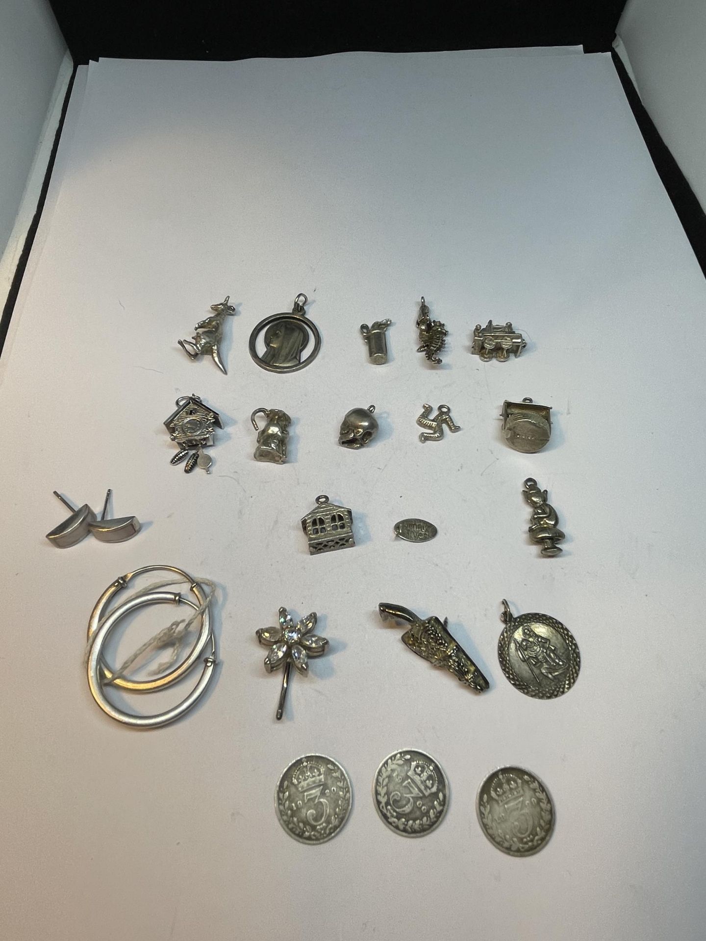 VARIOUS SILVER ITEMS TO INCLUDE FOURTEEN CHARMS, TWO PAIRS OFEARRINGS, THREE THREEPENCES 1899-