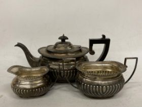 A VICTORIAN 1897 HALLMARKED CHESTER THREE PIECE TEA SET COMPRISING TEAPOT, SUGAR BOWL AND CREAM JUG,