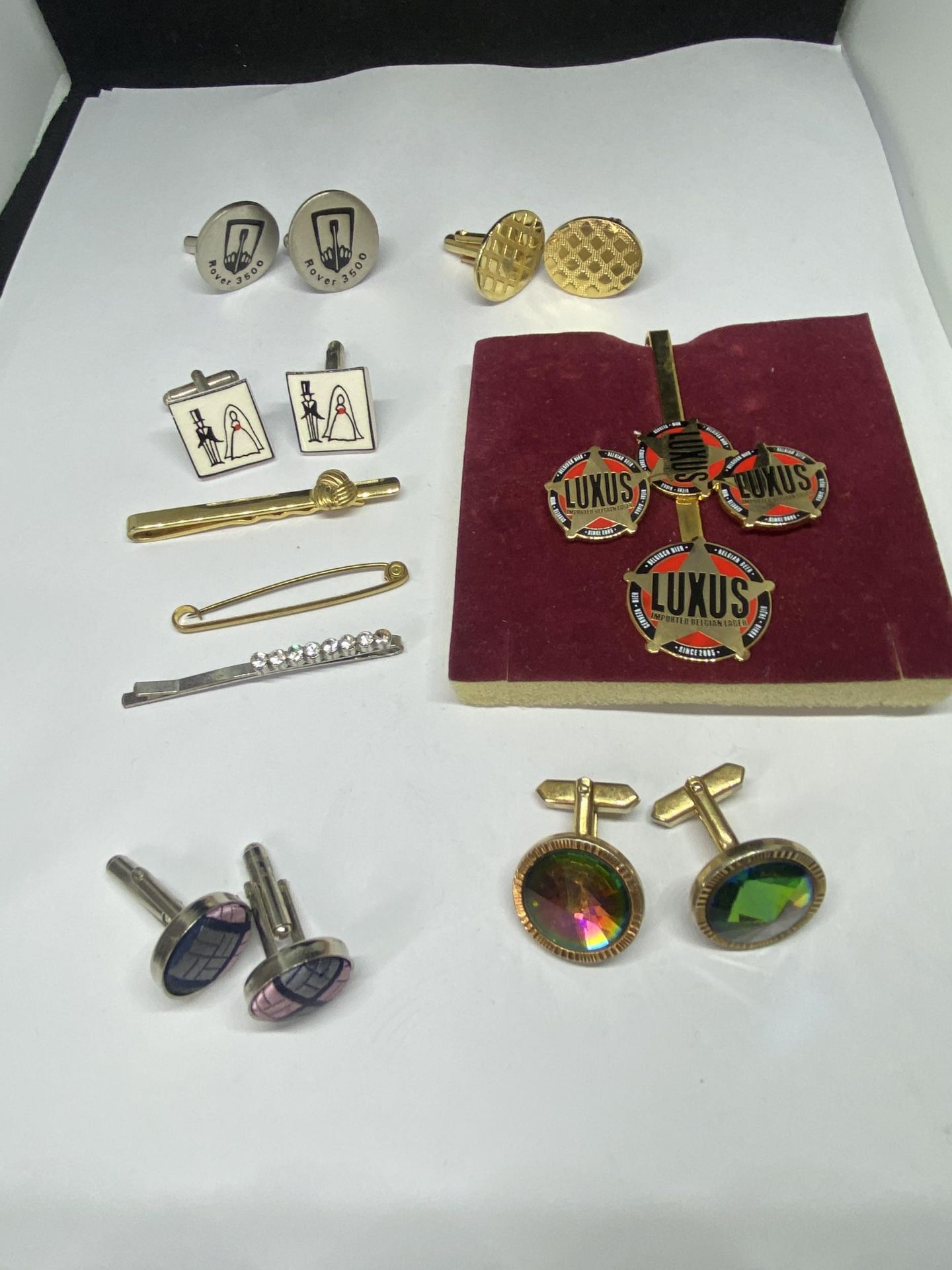 A COLLECTION OF CUFF LINKS AND TIE PINS