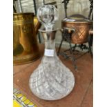 A CUT GLASS DECANTER WITH GLASS STOPPER AND HALLMARKED BIRMINGHAM SILVER COLLAR