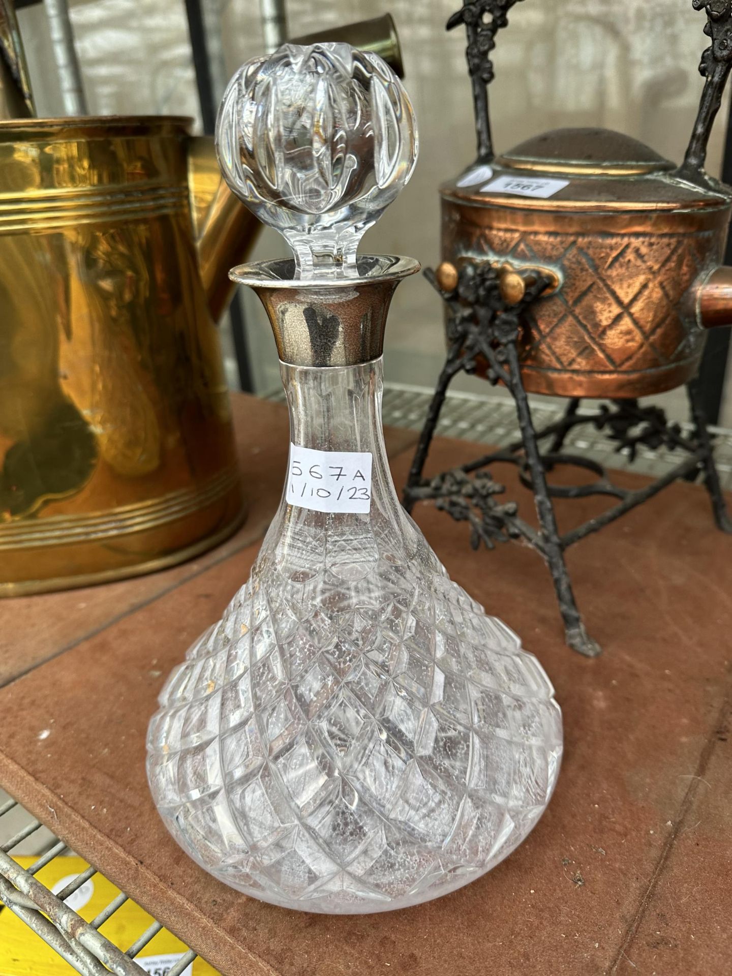 A CUT GLASS DECANTER WITH GLASS STOPPER AND HALLMARKED BIRMINGHAM SILVER COLLAR