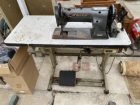 A SEIKO INDUSTRIAL SEWING MACHINE WITH TREADLE BASE