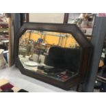 A MAHOGANY FRAMED OCTAGONAL MIRROR WITH BEVELLED GLASS