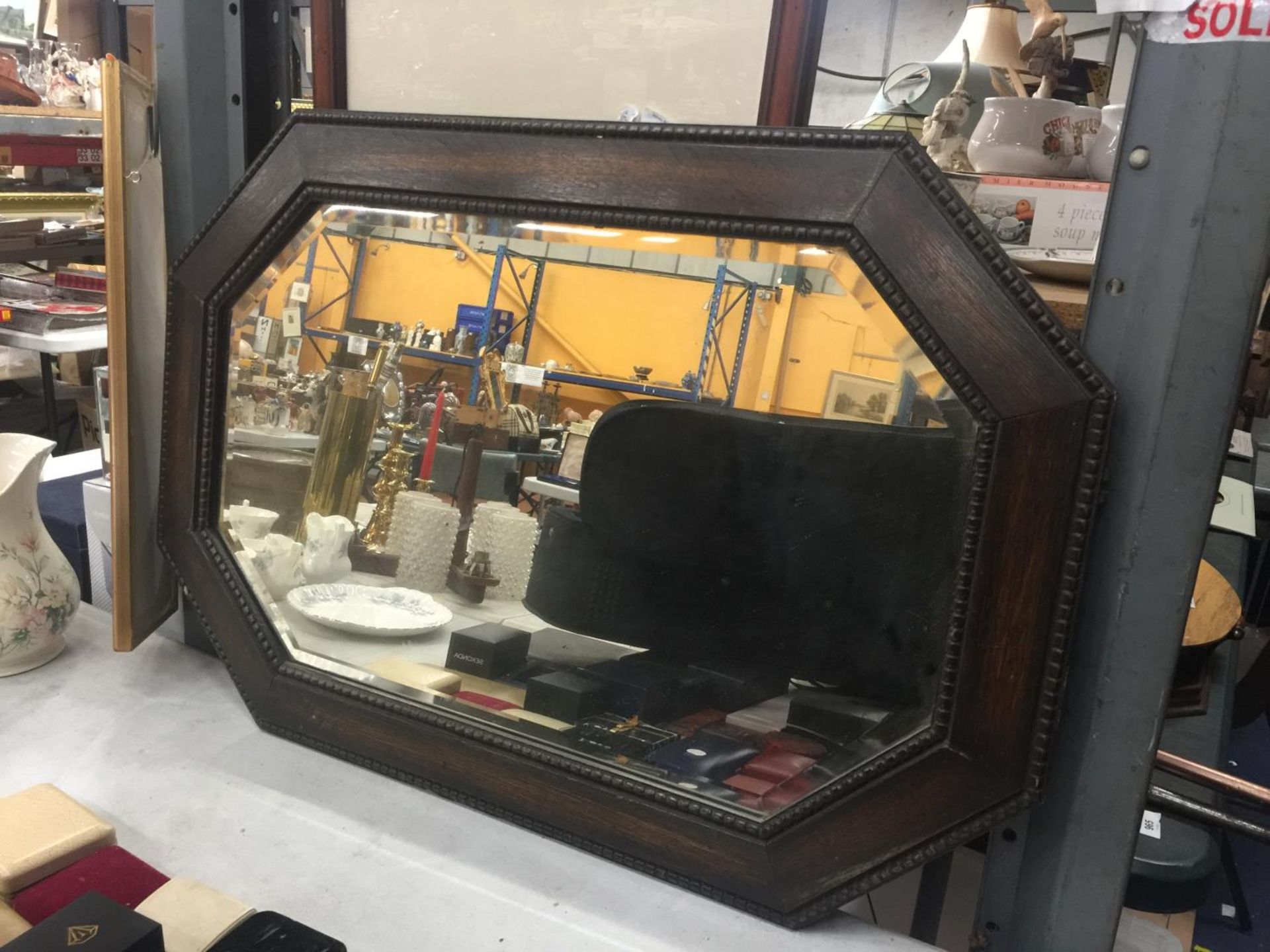 A MAHOGANY FRAMED OCTAGONAL MIRROR WITH BEVELLED GLASS