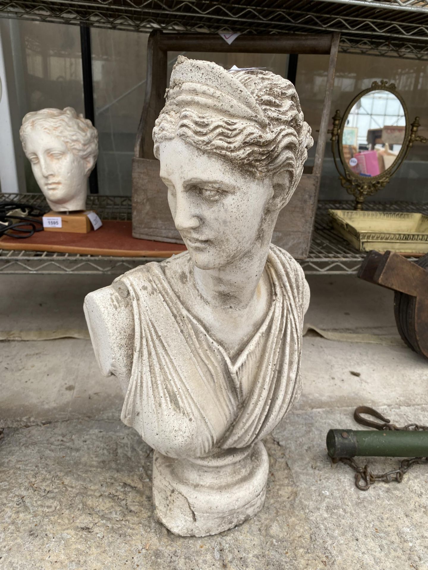 A RECONSTITUTED STONE BUST OF A FEMALE