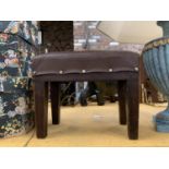 A VINTAGE LEATHER TOPPED MAHOGANY STOOL