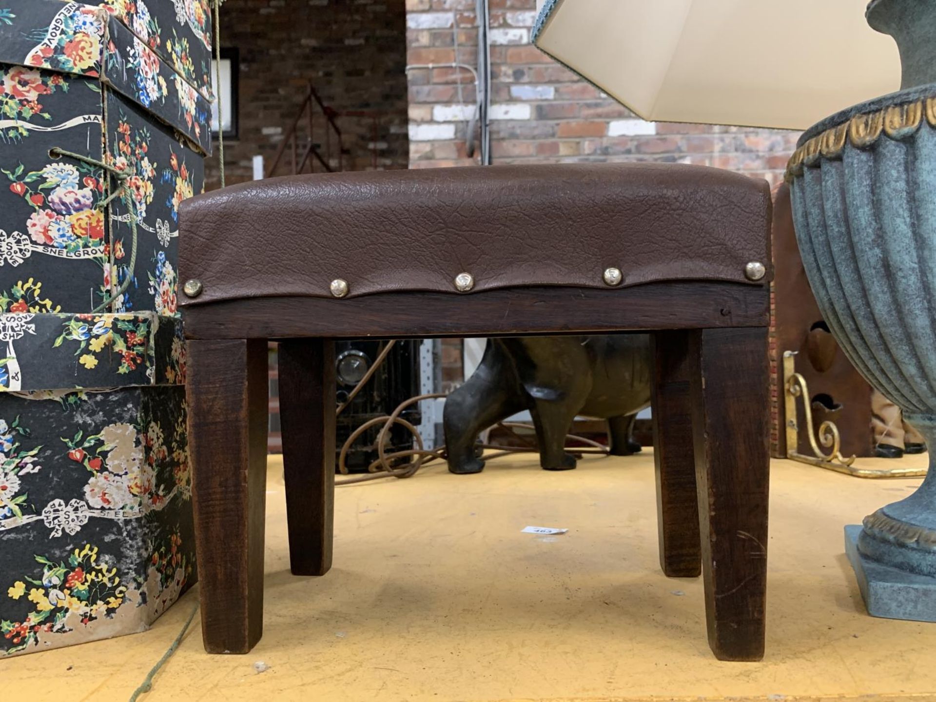 A VINTAGE LEATHER TOPPED MAHOGANY STOOL