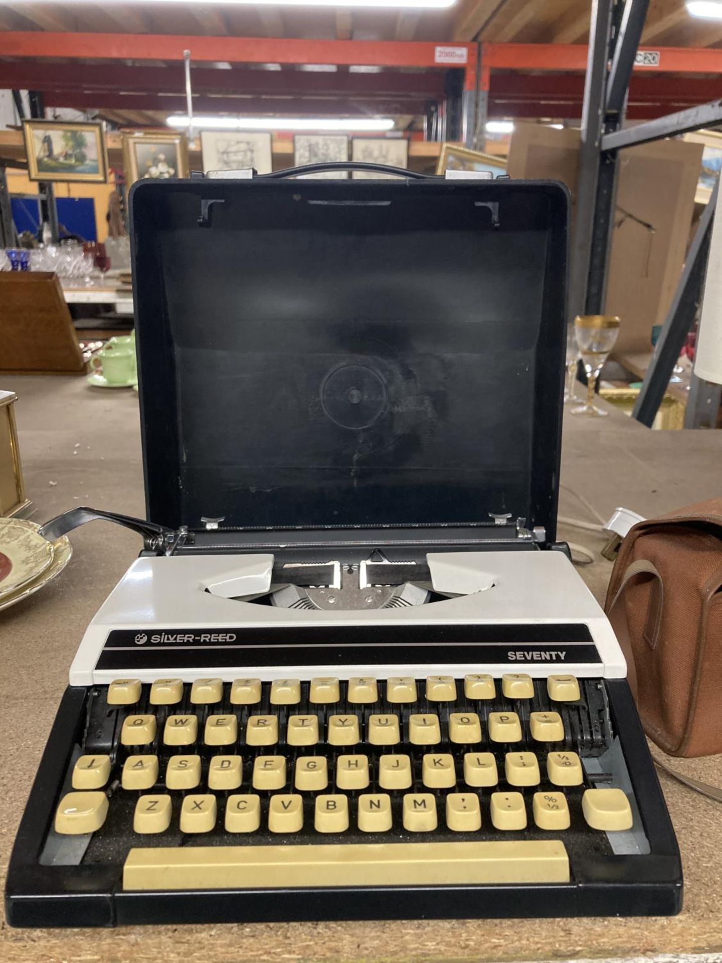 A VINTAGE CASED SILVER REED SEVENTY TYPE WRITER