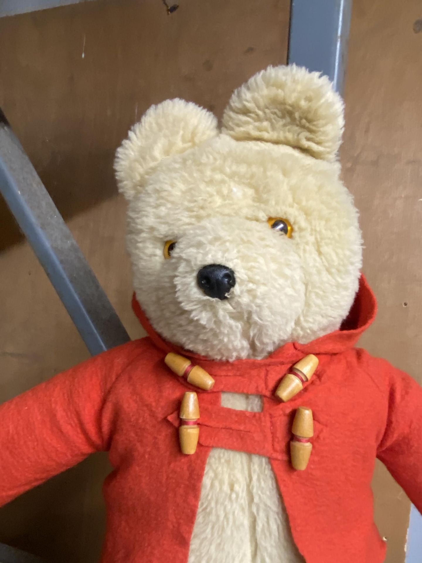 A SOFT TOY TEDDY BEAR IN A RED JACKET - Bild 2 aus 2