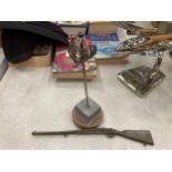 A SWORD PAPERWEIGHT AND A SMALL MODEL OF A RIFLE