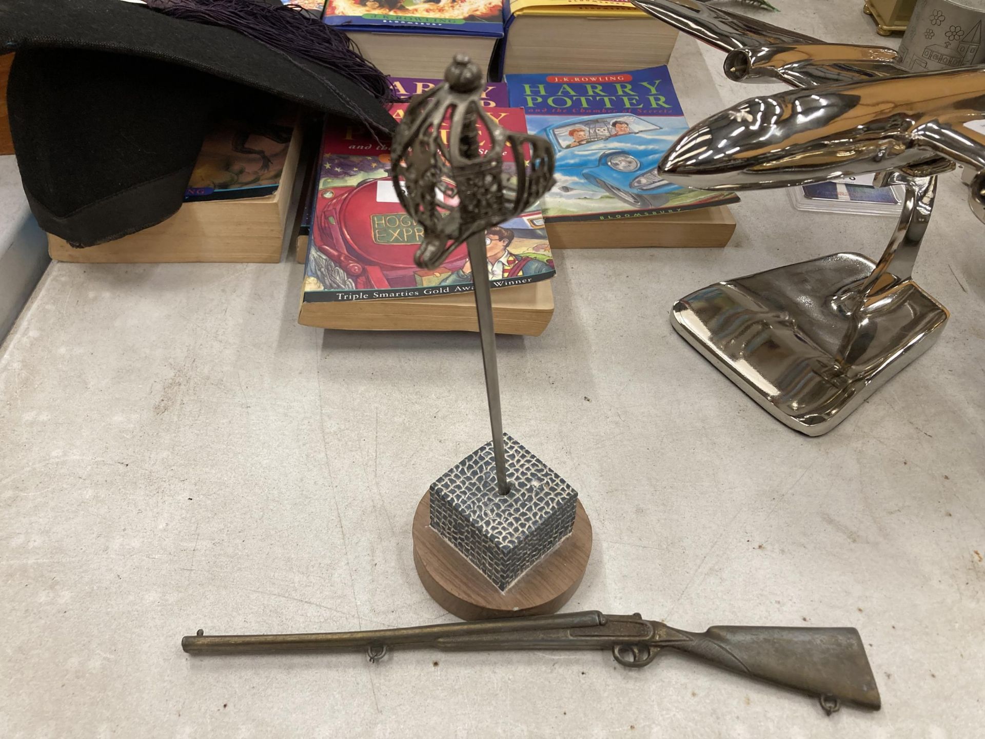 A SWORD PAPERWEIGHT AND A SMALL MODEL OF A RIFLE