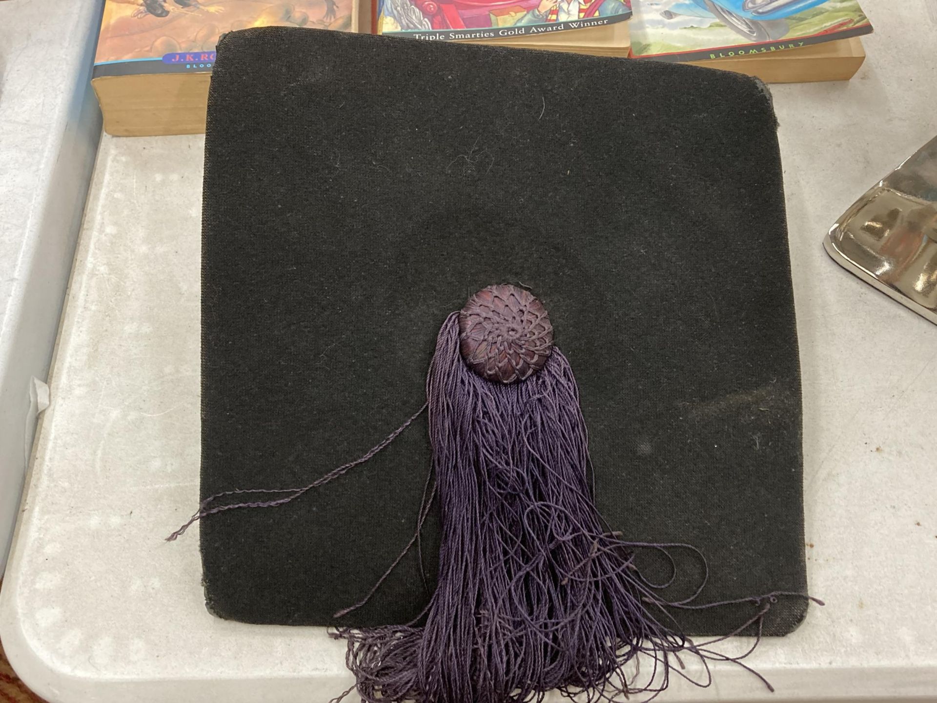 A UNIVERSITY MORTAR BOARD WITH A PURPLE TASSLE - Image 2 of 3