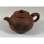 A CHINESE YIXING CLAY TEAPOT WITH FLORAL RELIEF MOULDED DESIGN, SEAL MARK TO BASE AND LID INNER,