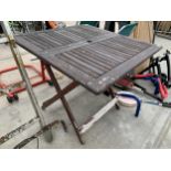 A FOLDING WOODEN PATIO TABLE