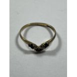 A 9 CARAT GOLD RING WITH THREE SAPPHIRES AND TWO CUBIC ZIRCONIAS IN A WISHBONE DESIGN SIZE L/M