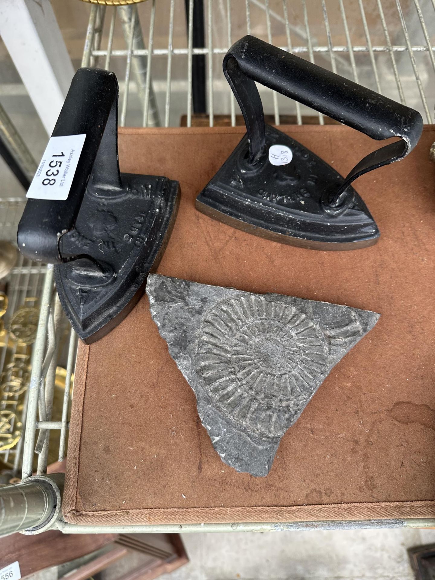 TWO VINTAGE FLAT IRONS AND A SLATE FOSSIL