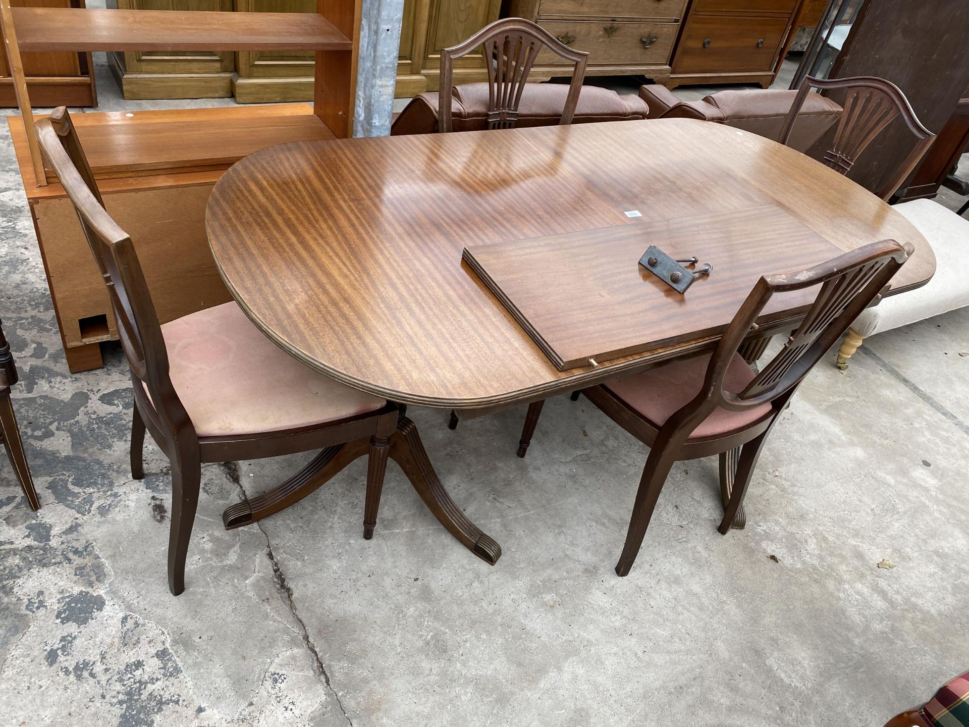 A MAHOGANY REGENCY STYLE TWIN-PEDESTAL EXTENDING DINING TABLE, 69 X 35" (LEAF 14")