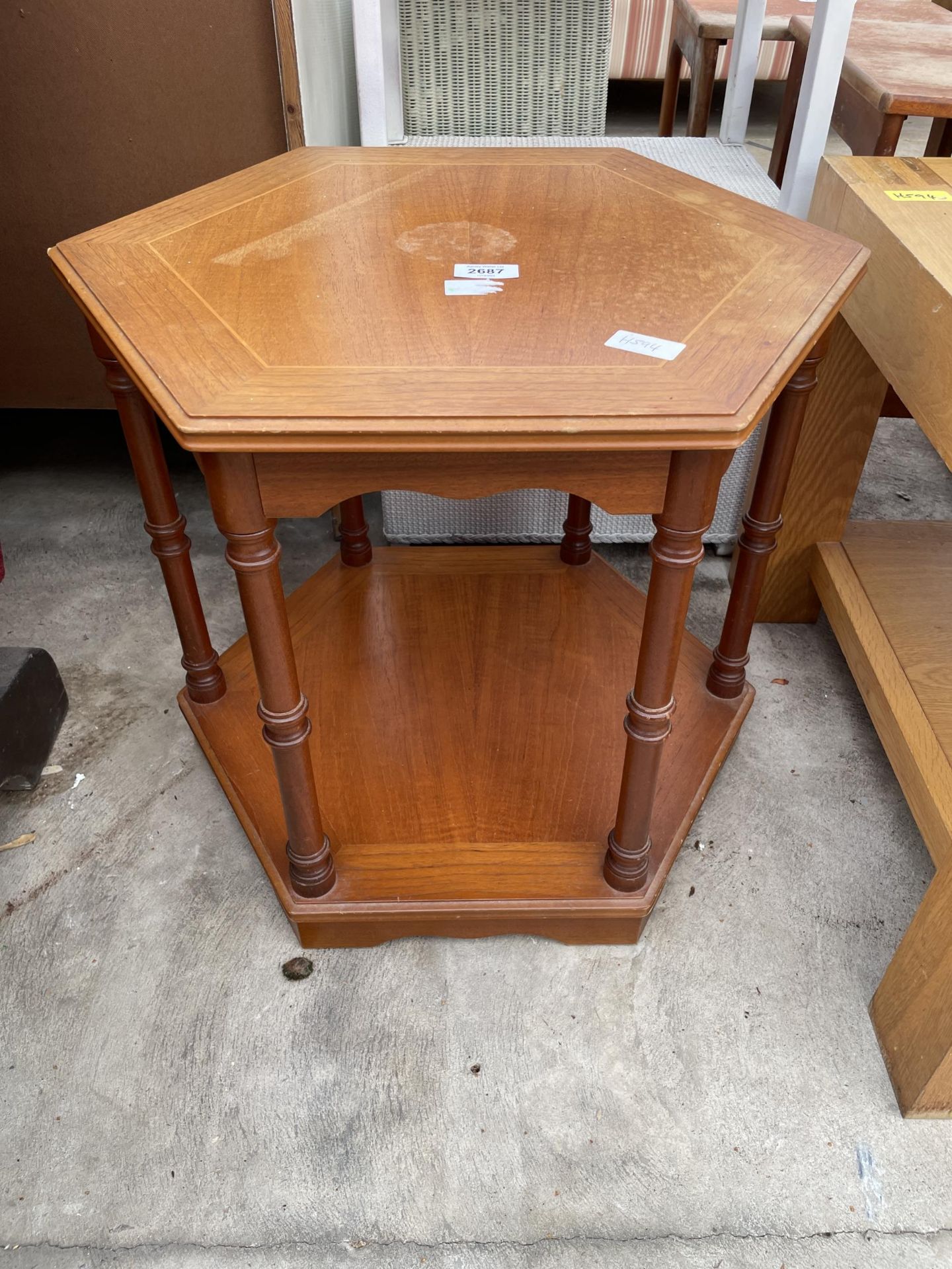 A MODERN HEXAGONAL OCCASIONAL TWO TIER TABLE ON TURNED LEGS