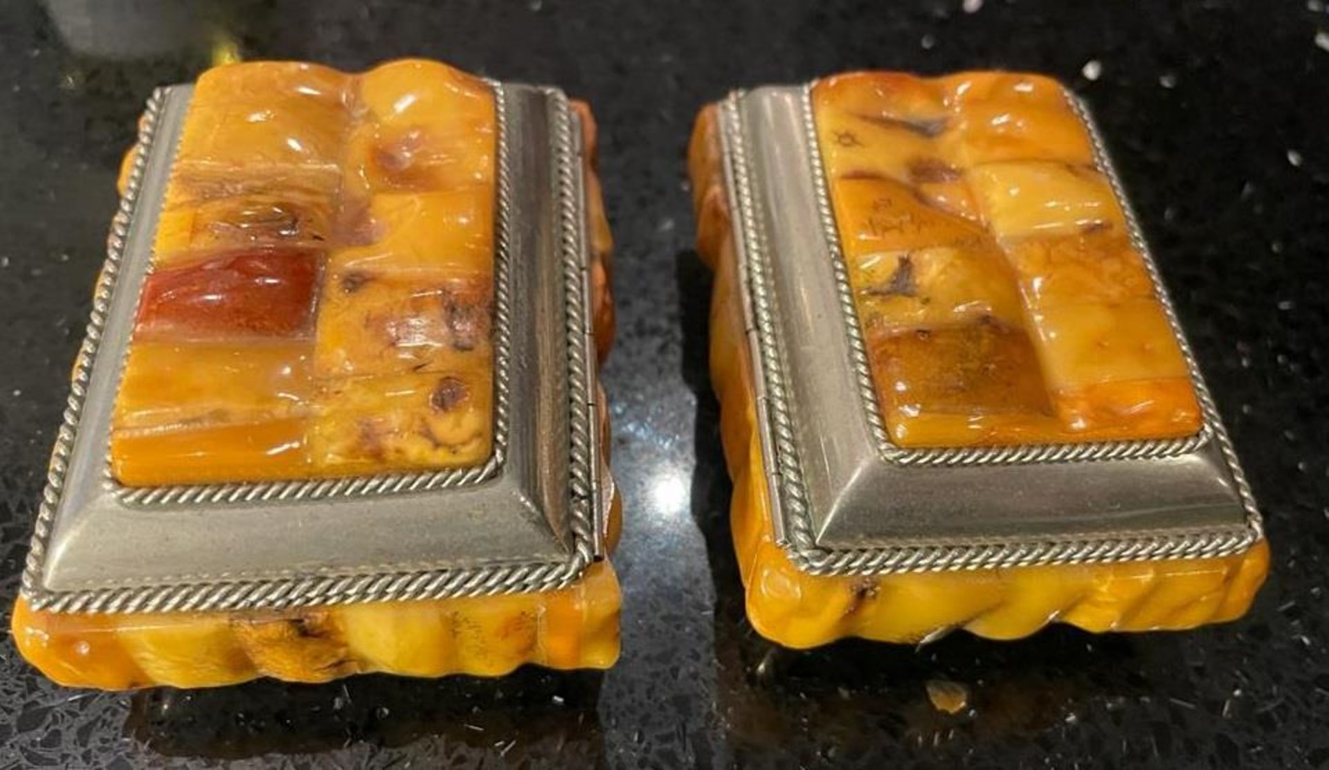 A PAIR OF VINTAGE, BELIEVED YELLOW AMBER, TRINKET BOXES WITH WHITE METAL BORDER AND BASES