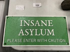 A CAST INSANE ASYLUM PLEASE ENTER WITH CAUTION SIGN
