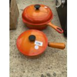 TWO VINTAGE ORANGE CAST IRON COOKING PANS, ONE LABELED LE CREUSET