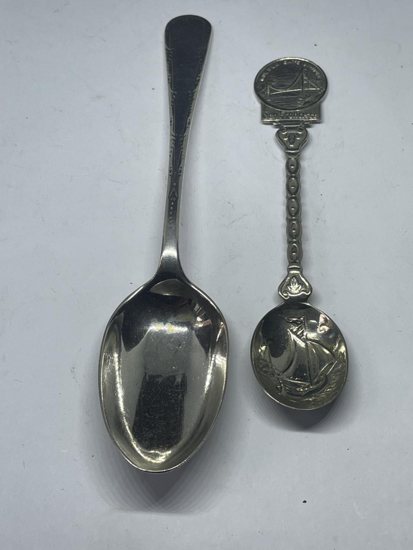 TWO SPOONS ONE HALLMARKED SHEFFIELD THE OTHER A SAN FRANISCO COMMEMORATIVE