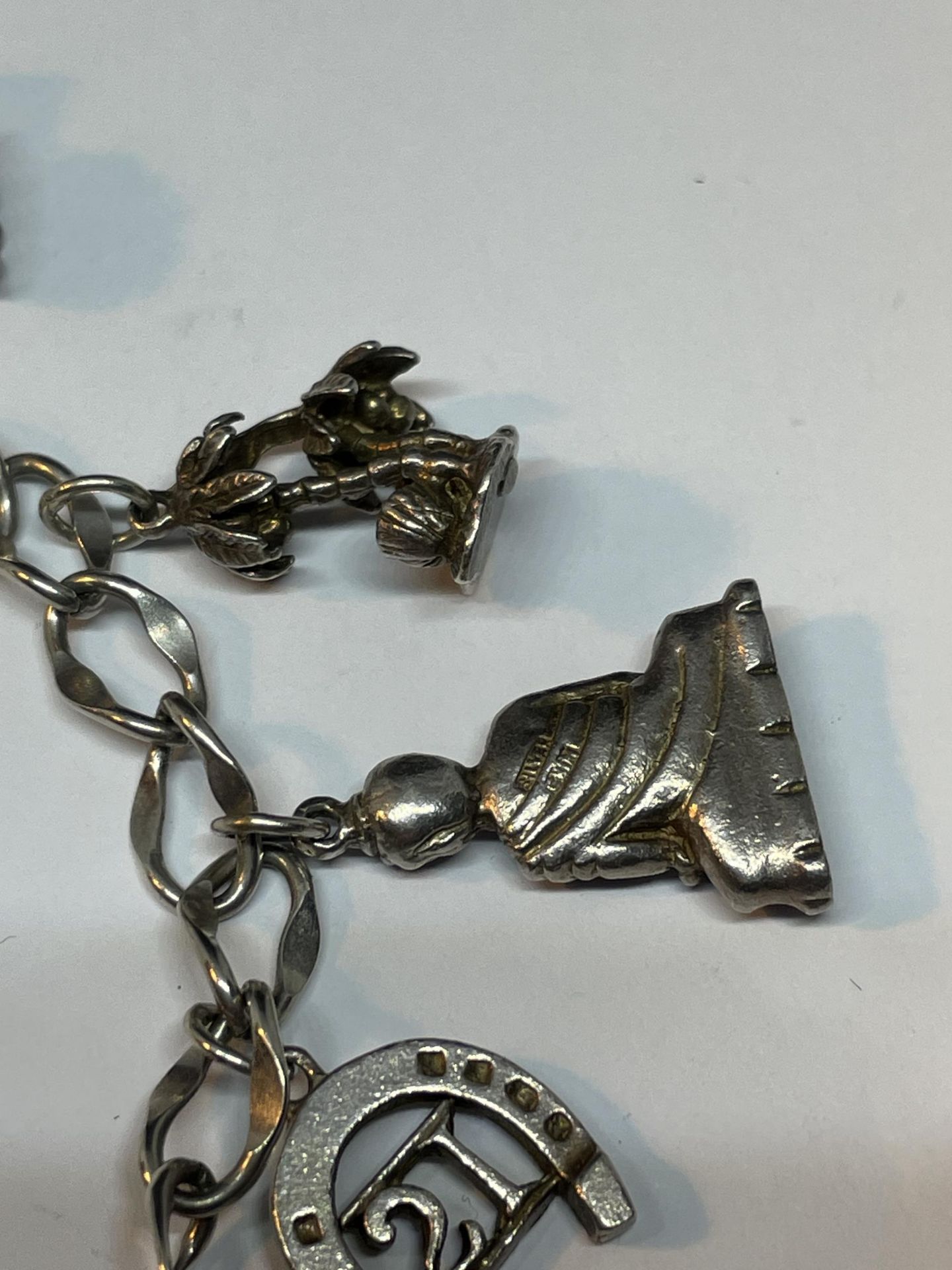 A SILVER CHARM BRACELET WITH NINE CHARMS - Image 3 of 4