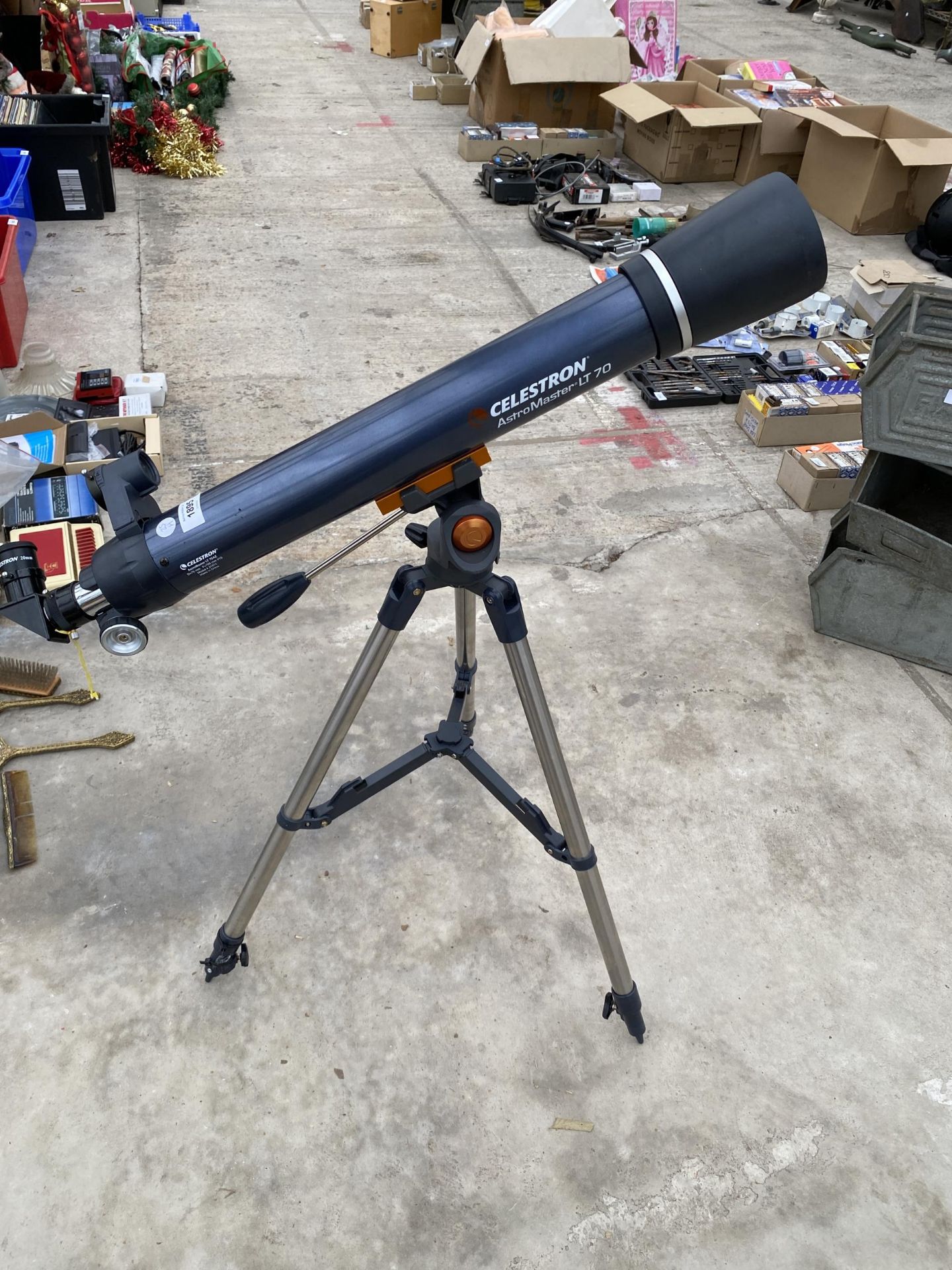 A CELESTRON ASTRO MASTER LT70 TELESCOPE WITH TRIPOD STAND