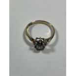 A 9 CARAT GOLD RING WITH BLUE TOPAZ AND CUBIC ZIRCONIAS IN A FLOWER DESIGN SIZE P