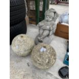 A RECONSTITUTED FIGURE OF A SEATED GNOME AND TWO WATER FEATURE BALLS