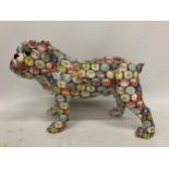 A LARGE BULLDOG WITH CONTINENTAL BOTTLE TOP DECORATION, HEIGHT 26CM, LENGTH 37CM