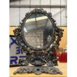 A VICTORIAN STYLE CAST DRESSING TABLE MIRROR WITH ORNATE FLORAL DESIGN