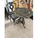 A DECORATIVE VINTAGE CAST IRON BISTRO TABLE AND A CAST ALLOY BISTRO CHAIR