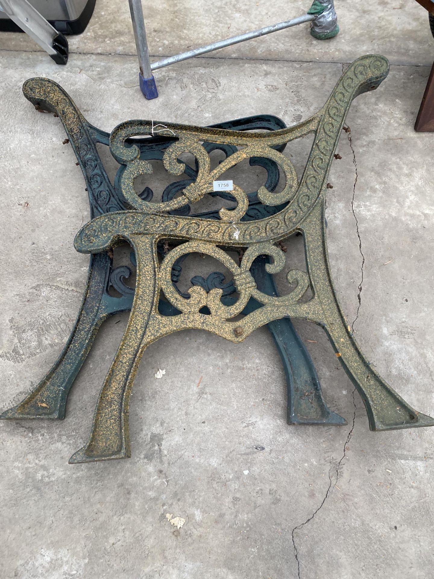 A PAIR OF DECORATIVE CAST IRON BENCH ENDS