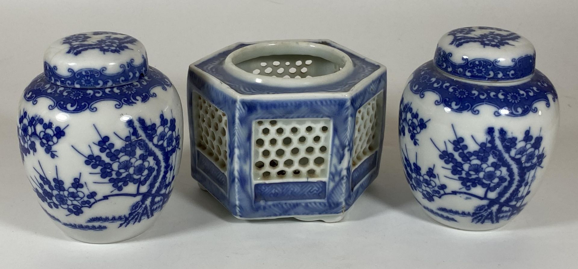 THREE ITEMS - A PAIR OF JAPANESE BLUE AND WHITE FLORAL GINGER JARS AND A RETICULATED POT, HEIGHT