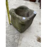 A SMALL SQUARE STONE PLANTER