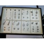 A TRAY CONTAINING TWENTY FIVE PAIRS OF SILVER EARRINGS