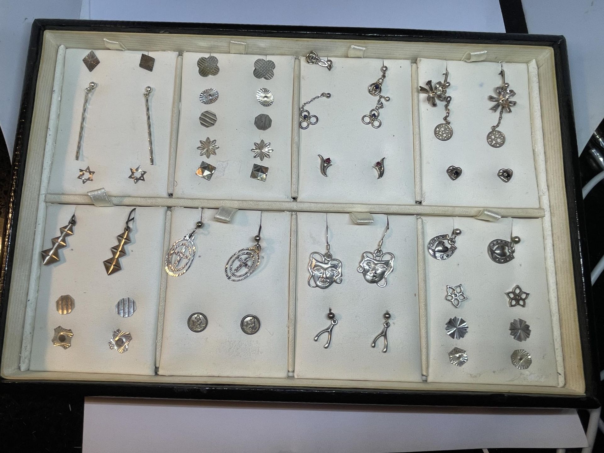 A TRAY CONTAINING TWENTY FIVE PAIRS OF SILVER EARRINGS