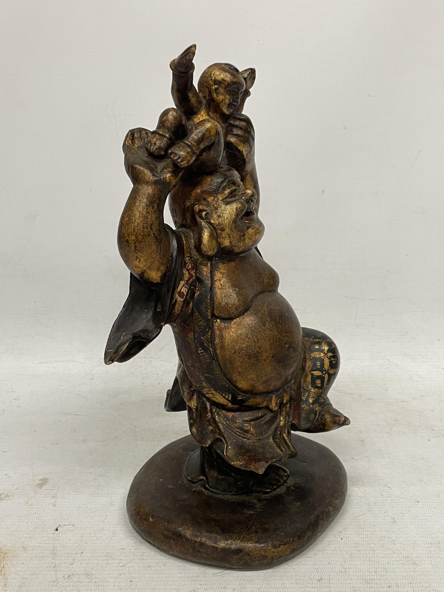 AN ORIENTAL FIGURE OF A BUDDHA HOLDING A BOY - Image 2 of 4