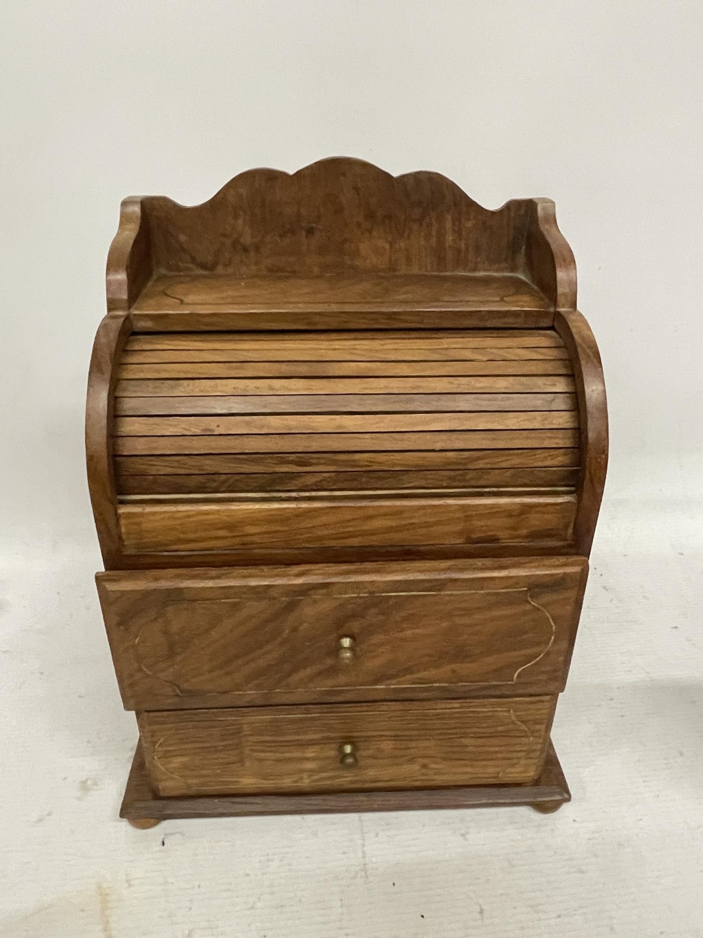 AN APPRENTICE PIECE ROLL TOP DESK - ROLL TOP OPENS WHEN THE TOP DRAWER IS OPENED