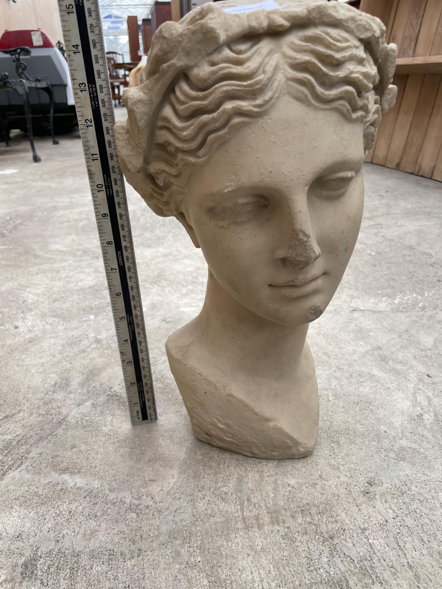 A SMALL RECONSTITUTED STONE GARDEN FEMALE BUST (H:38CM)