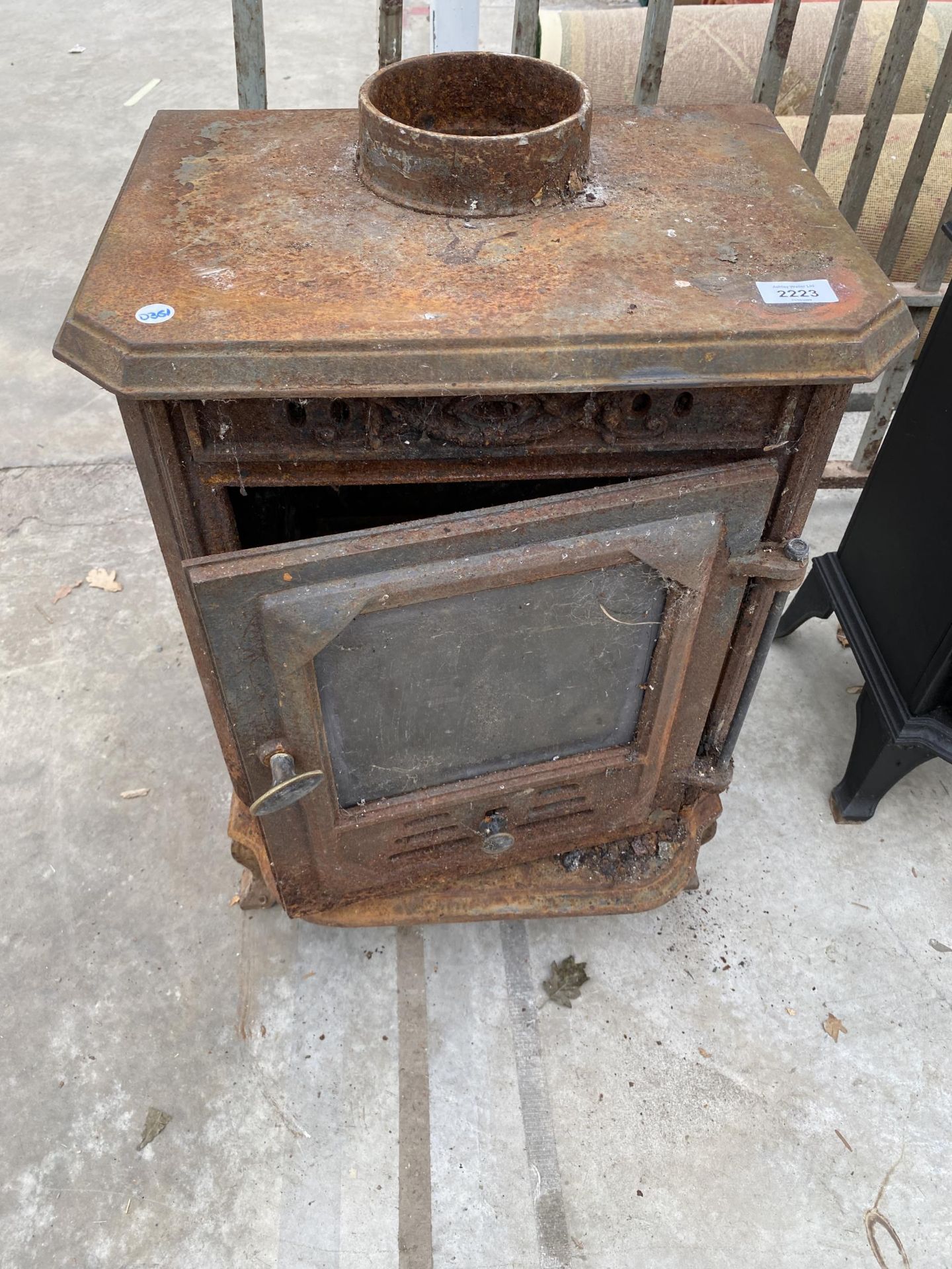 A VINTAGE CAST IRON LOG BURNER