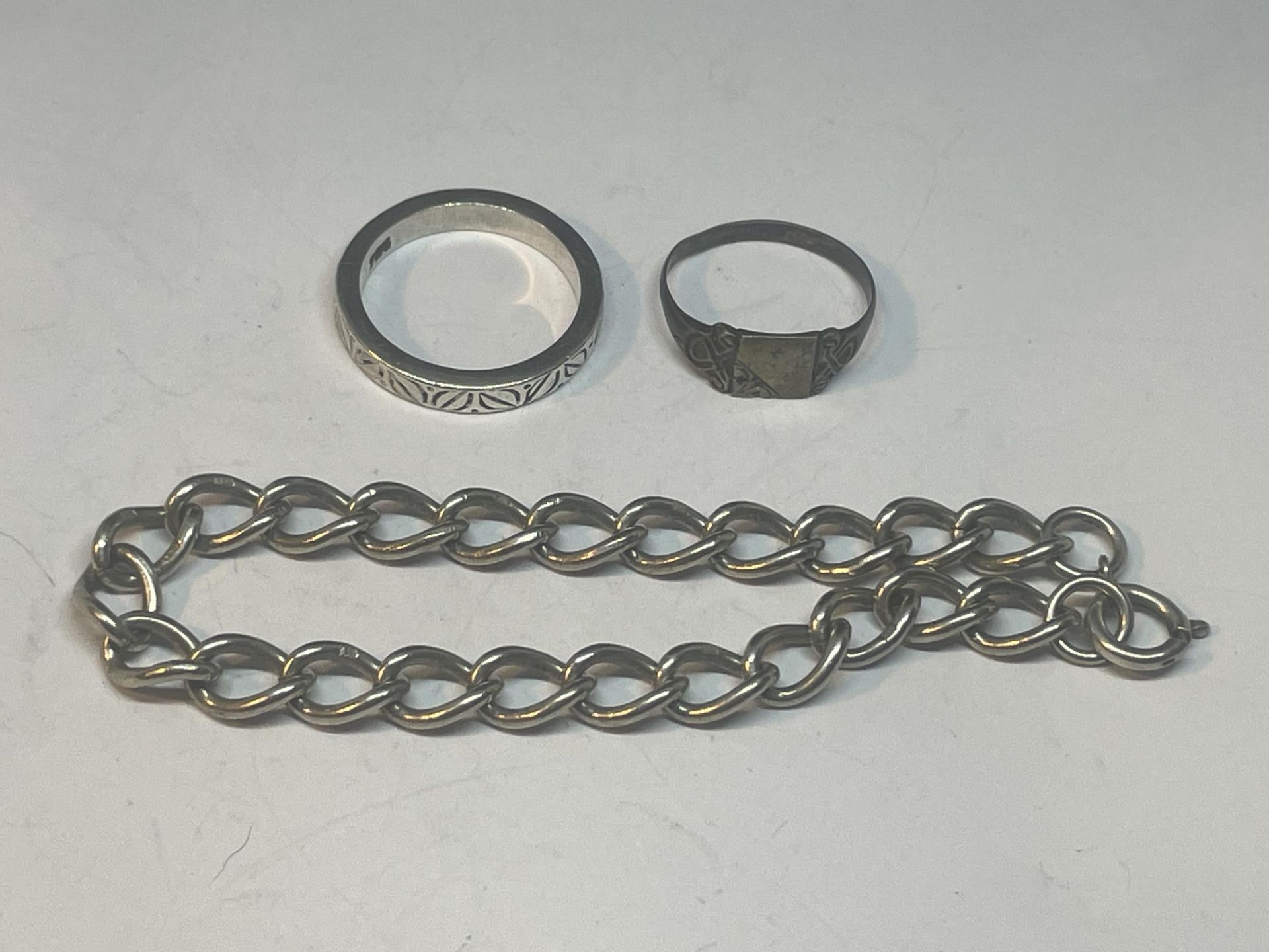 A SILVER BRACELET AND TWO SILVER RINGS