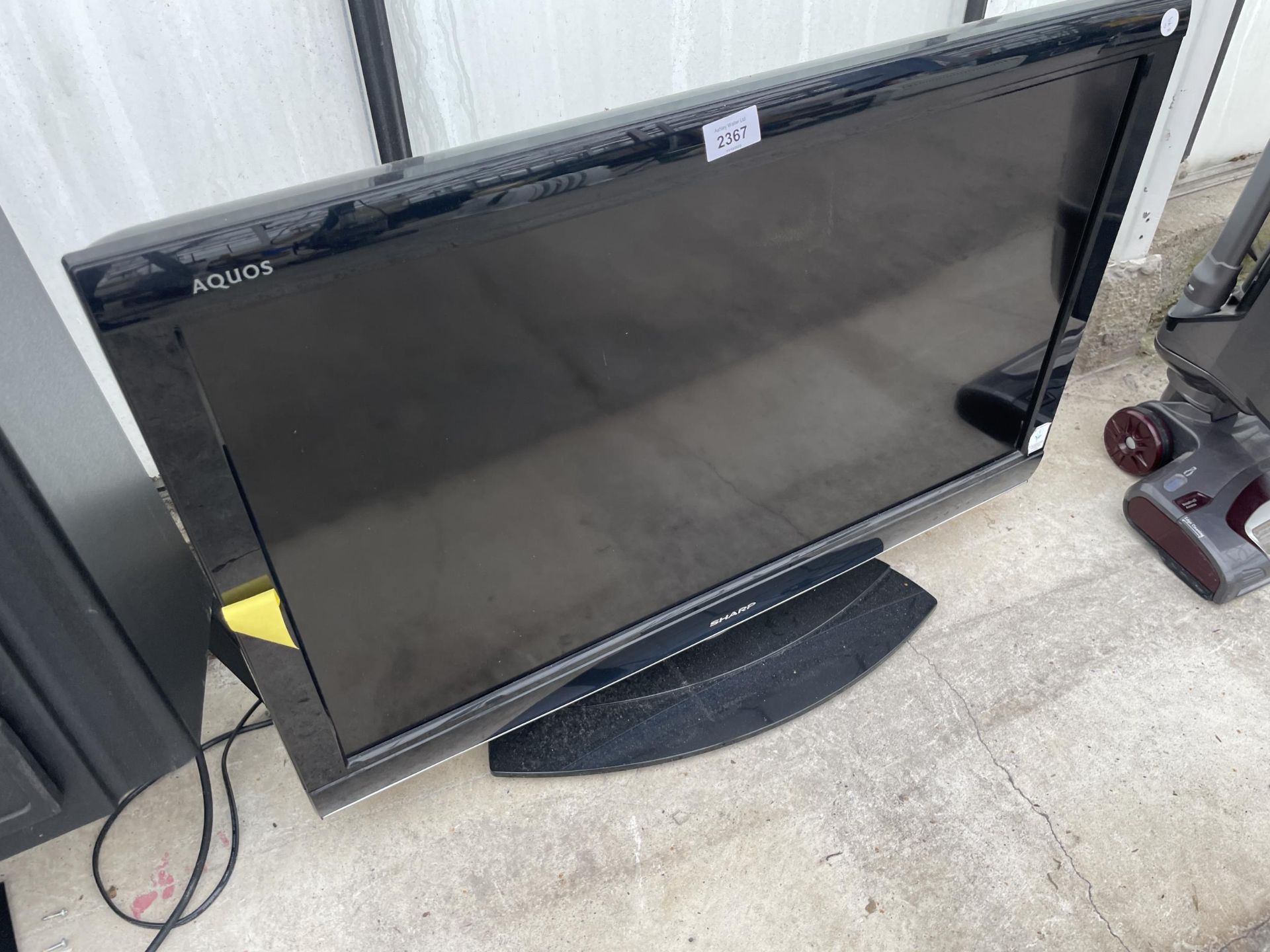 A SHARP 32" TELEVISION WITH REMOTE CONTROL
