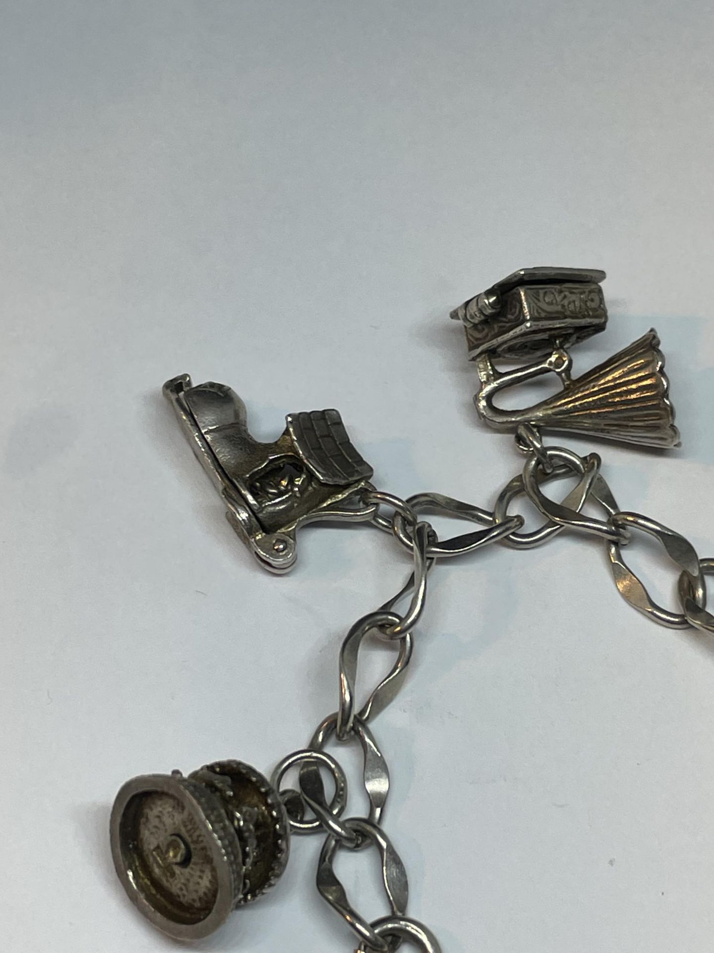 A SILVER CHARM BRACELET WITH NINE CHARMS - Image 2 of 4